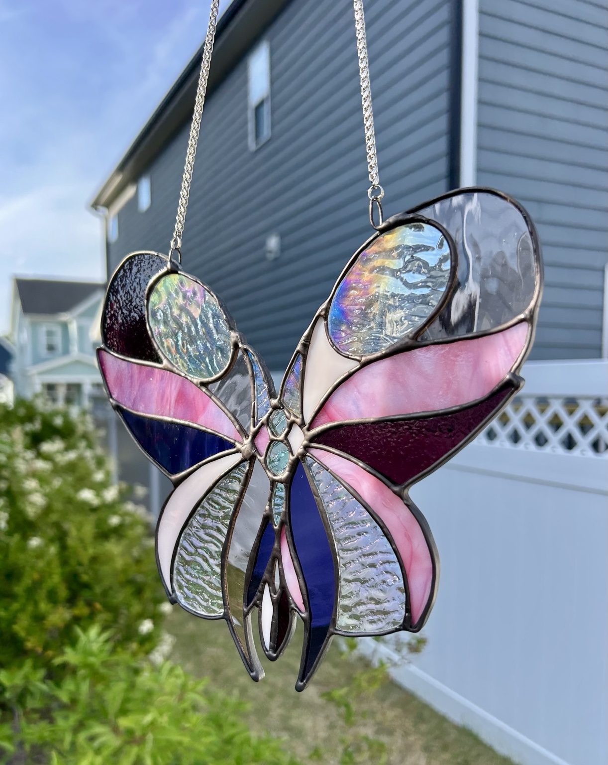 Laura's handmade stained glass butterfly in pink, purple and iridescent textured glass, donated to the Mes Papillons Foundation fundraising gala
